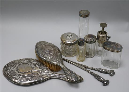 An Edwardian Art Nouveau silver mounted mirror and brush and seven other items included plated ware.